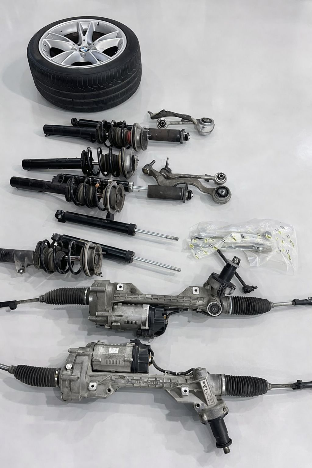 All replaced parts from BMW Z4 including steering rack, shock absorbers, link rods and tyre
